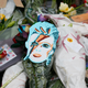 Flowers and tributes lie at a mural of David Bowie in Brixton, south London, January 11, 2016. David Bowie, a music legend who used daringly androgynous displays of sexuality and glittering costumes to frame legendary rock hits "Ziggy Stardust" and "Space Oddity", has died of cancer.